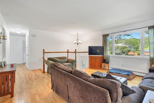 19 Decker Dr, Washingtonville, NY 10992 - living area with attic access, light wood finished floors, a chandelier, and a baseboard radiator