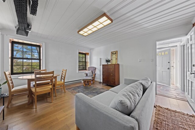 162 Lake Dr, Lake Peekskill, NY 10537 - living room featuring a baseboard radiator, light wood-style flooring, wooden ceiling, and ornamental molding