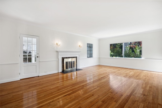 119 Knickerbocker Rd, Manhasset, NY 11030 - unfurnished living room with a fireplace with flush hearth, crown molding, wood finished floors, and baseboards