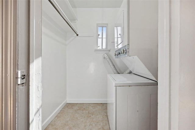 119 Knickerbocker Rd, Manhasset, NY 11030 - laundry area with stacked washing machine and dryer, baseboards, and light tile patterned flooring