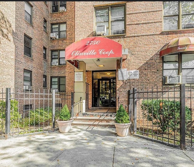 2750 Olinville Ave Unit 4C, Bronx, NY 10467 - entrance to property with brick siding and cooling unit