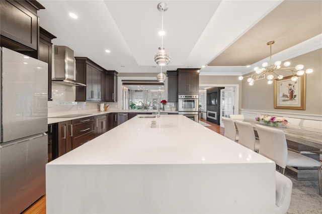 3 Deb St, Plainview, NY 11803 - kitchen featuring wall chimney range hood, appliances with stainless steel finishes, dark brown cabinetry, light countertops, and a sink