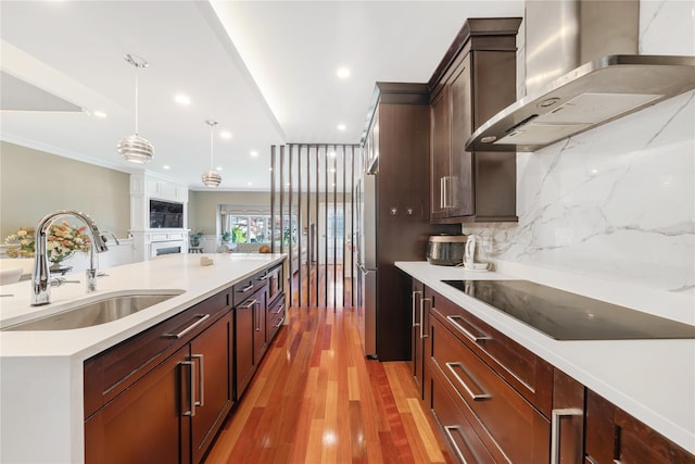 3 Deb St, Plainview, NY 11803 - kitchen featuring wall chimney exhaust hood, black electric cooktop, a sink, light countertops, and light wood-style floors