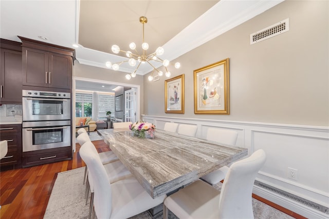 3 Deb St, Plainview, NY 11803 - dining area with a chandelier, crown molding, dark wood-style floors, wainscoting, and a decorative wall
