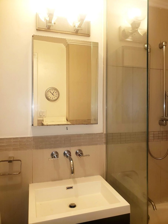 2311 21st Ave Unit 3C, Astoria, NY 11105 - bathroom featuring a shower, tile walls, and vanity
