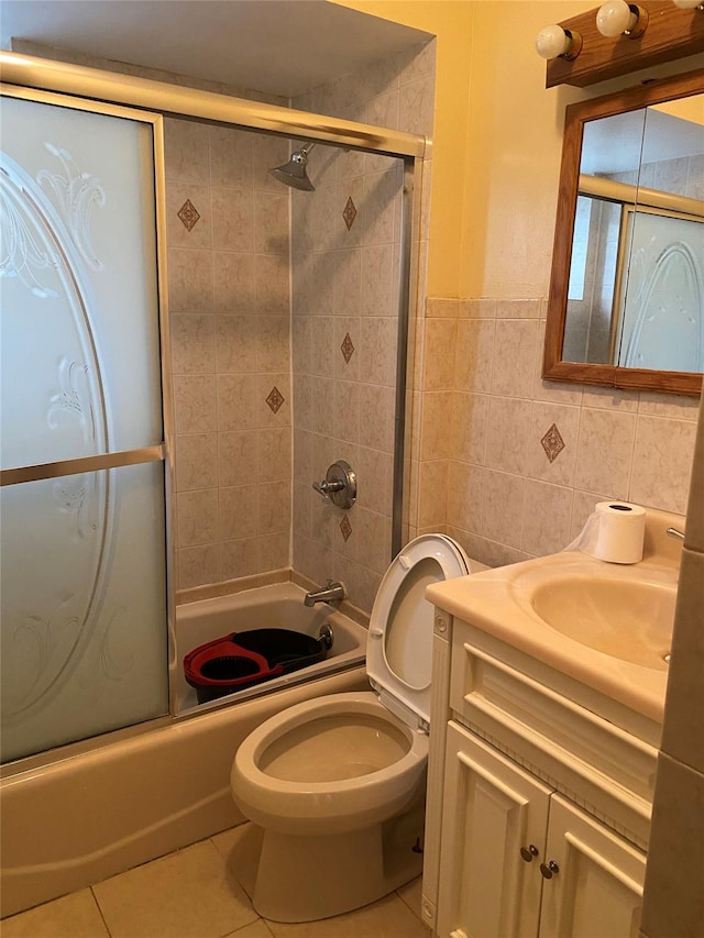 1646 Troy Ave, Brooklyn, NY 11234 - bathroom featuring tile walls, vanity, tile patterned floors, bath / shower combo with glass door, and toilet