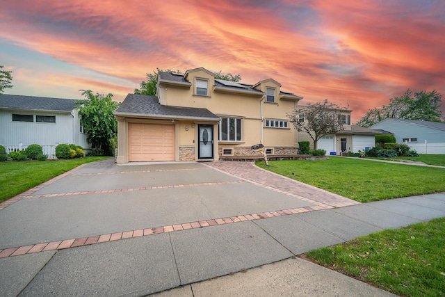 5 Forest Rd, Valley Stream, NY 11581 - traditional-style house featuring stucco siding, asphalt driveway, a garage, a front lawn, and stone siding