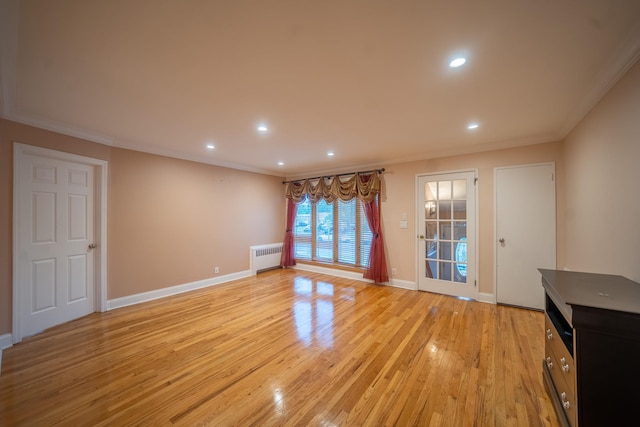 5 Forest Rd, Valley Stream, NY 11581 - unfurnished living room featuring ornamental molding, radiator heating unit, recessed lighting, light wood finished floors, and baseboards