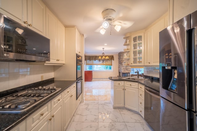 5 Forest Rd, Valley Stream, NY 11581 - kitchen with appliances with stainless steel finishes, a ceiling fan, light marble finish flooring, a sink, and backsplash