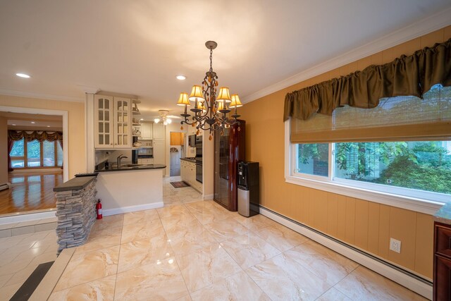 5 Forest Rd, Valley Stream, NY 11581 - kitchen featuring baseboard heating, dark countertops, a sink, a chandelier, and plenty of natural light
