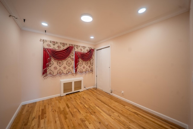 5 Forest Rd, Valley Stream, NY 11581 - empty room featuring light wood finished floors, baseboards, crown molding, recessed lighting, and radiator heating unit