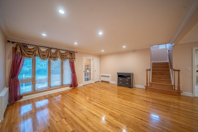 5 Forest Rd, Valley Stream, NY 11581 - unfurnished living room with radiator, ornamental molding, light wood finished floors, stairs, and baseboards