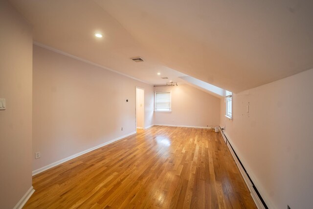 5 Forest Rd, Valley Stream, NY 11581 - additional living space with light wood finished floors, a baseboard heating unit, recessed lighting, and baseboards