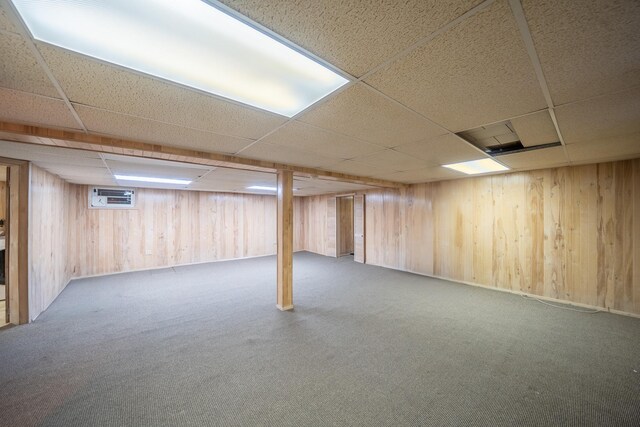 5 Forest Rd, Valley Stream, NY 11581 - finished basement featuring a paneled ceiling, carpet flooring, and wood walls