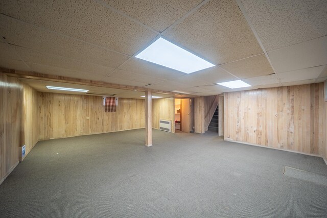 5 Forest Rd, Valley Stream, NY 11581 - finished basement featuring wood walls, carpet flooring, a drop ceiling, stairs, and heating unit