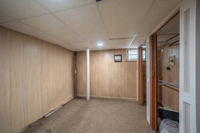 5 Forest Rd, Valley Stream, NY 11581 - basement with a paneled ceiling, carpet floors, and wooden walls