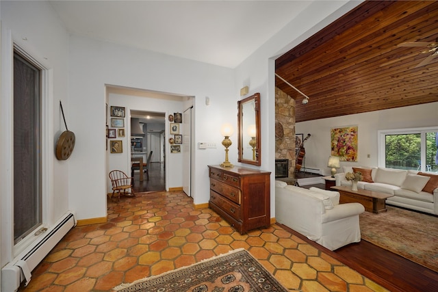 31 Greenlawn Rd, Katonah, NY 10536 - living area featuring a baseboard heating unit, wood ceiling, vaulted ceiling, a stone fireplace, and baseboards