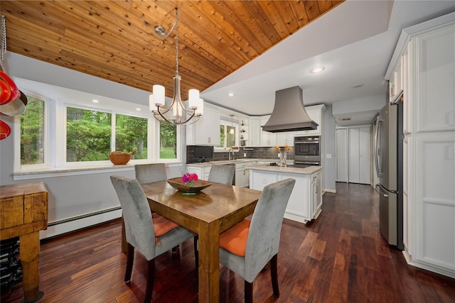 31 Greenlawn Rd, Katonah, NY 10536 - dining area featuring vaulted ceiling, a baseboard radiator, healthy amount of natural light, a chandelier, and dark wood-style floors