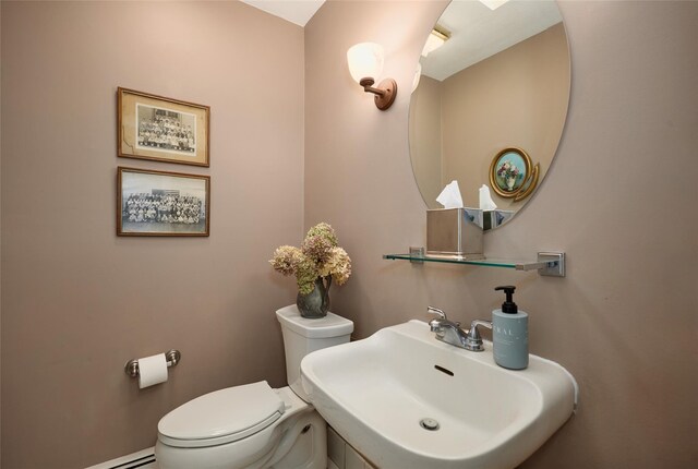 31 Greenlawn Rd, Katonah, NY 10536 - half bathroom with a sink, toilet, and a baseboard radiator