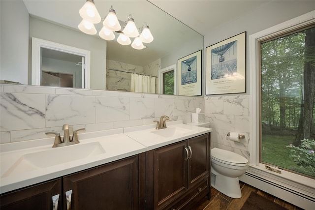 31 Greenlawn Rd, Katonah, NY 10536 - bathroom featuring baseboard heating, a chandelier, double vanity, toilet, and tile walls