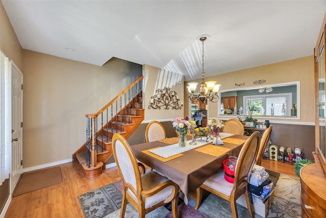 1623 Washington Ave, Bohemia, NY 11716 - dining room featuring a chandelier, light wood-style flooring, and stairs