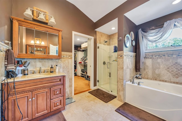 1623 Washington Ave, Bohemia, NY 11716 - bathroom featuring a shower stall, a spacious closet, a garden tub, vanity, and tile walls