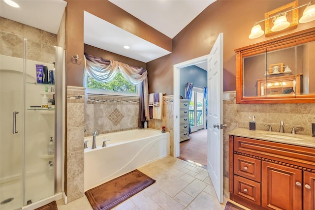 1623 Washington Ave, Bohemia, NY 11716 - full bathroom with tile walls, a shower stall, vanity, tile patterned floors, and a garden tub