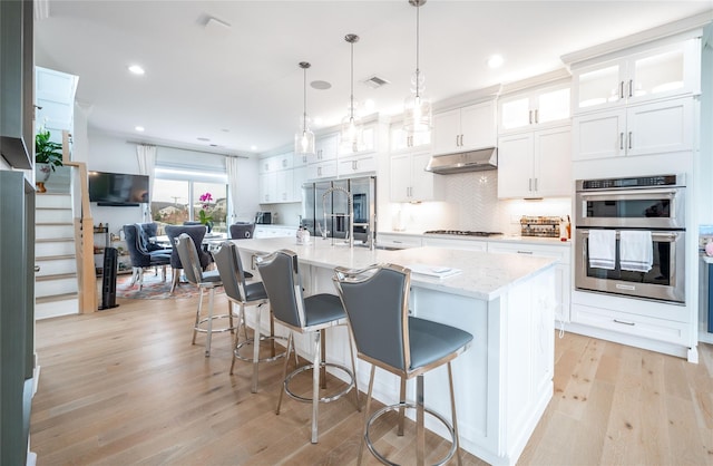 5 Brentwood Cir, Danbury, CT 06810 - kitchen featuring stainless steel appliances, light wood-style flooring, white cabinetry, glass insert cabinets, and a large island