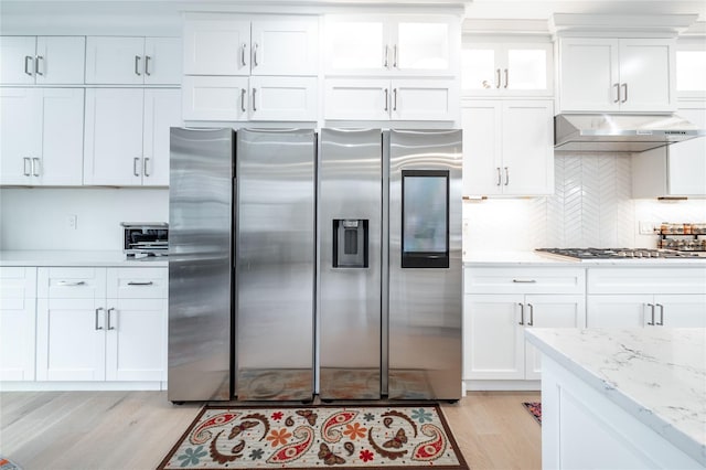 5 Brentwood Cir, Danbury, CT 06810 - kitchen with appliances with stainless steel finishes, under cabinet range hood, light wood-type flooring, white cabinets, and tasteful backsplash