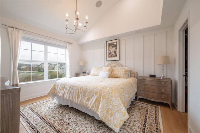 5 Brentwood Cir, Danbury, CT 06810 - bedroom with light wood-style flooring, a chandelier, a decorative wall, and vaulted ceiling