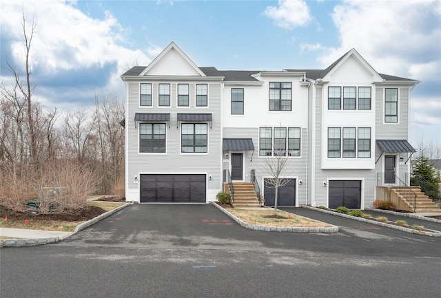 5 Brentwood Cir, Danbury, CT 06810 - view of front of home featuring an attached garage, driveway, a standing seam roof, and metal roof