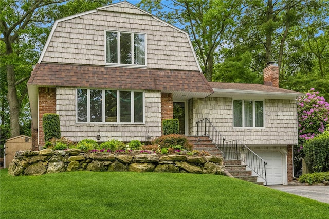 2 Caryl Pl, Kings Park, NY 11754 - view of front of house with a shingled roof, an attached garage, a front yard, and a gambrel roof