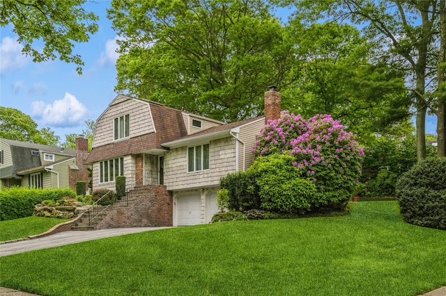 2 Caryl Pl, Kings Park, NY 11754 - view of front of home featuring an attached garage, a front yard, a chimney, and a gambrel roof