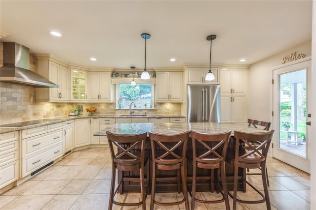 2 Caryl Pl, Kings Park, NY 11754 - kitchen with freestanding refrigerator, wall chimney exhaust hood, light tile patterned floors, a sink, and backsplash