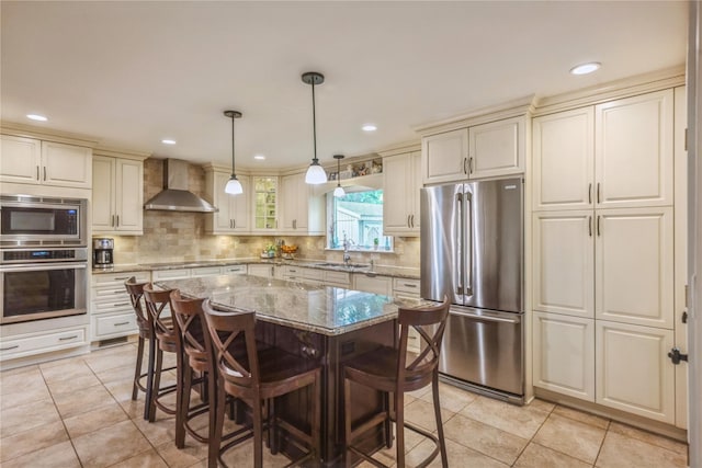 2 Caryl Pl, Kings Park, NY 11754 - kitchen featuring stainless steel appliances, wall chimney range hood, a sink, a kitchen breakfast bar, and recessed lighting