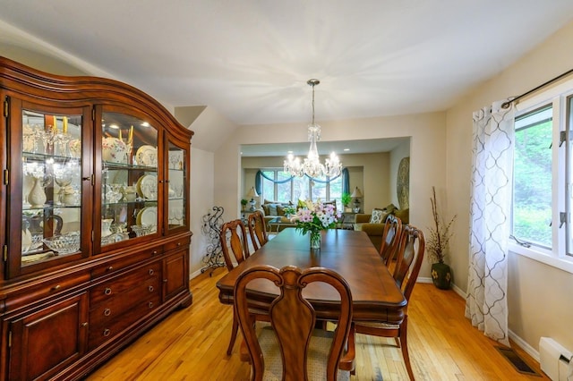 2 Caryl Pl, Kings Park, NY 11754 - dining room with a chandelier, light wood-style floors, baseboards, and a baseboard radiator