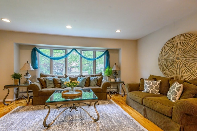 2 Caryl Pl, Kings Park, NY 11754 - living area featuring healthy amount of natural light, recessed lighting, wood finished floors, baseboards, and baseboard heating