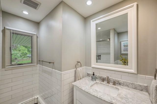 2 Caryl Pl, Kings Park, NY 11754 - bathroom with vanity, tile walls, wainscoting, tiled shower, and recessed lighting