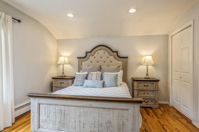2 Caryl Pl, Kings Park, NY 11754 - bedroom with lofted ceiling, a baseboard heating unit, light wood-style floors, recessed lighting, and a closet