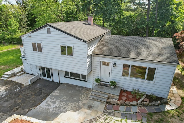 1 Renee Gate St, Cortlandt Manor, NY 10567 - view of front of home with a shingled roof, a chimney, and a patio