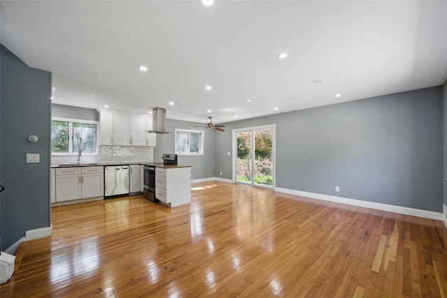 1 Renee Gate St, Cortlandt Manor, NY 10567 - kitchen featuring appliances with stainless steel finishes, extractor fan, a peninsula, open floor plan, and plenty of natural light