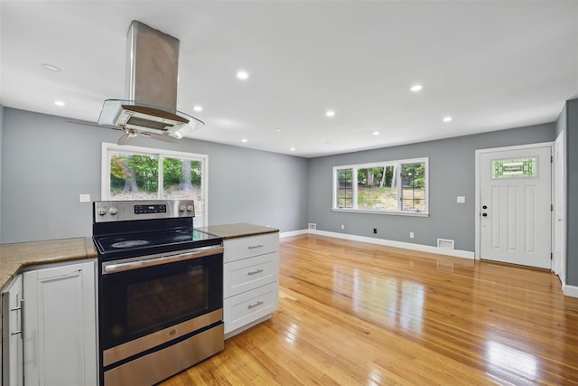 1 Renee Gate St, Cortlandt Manor, NY 10567 - kitchen with electric range, island exhaust hood, light wood finished floors, white cabinets, and recessed lighting