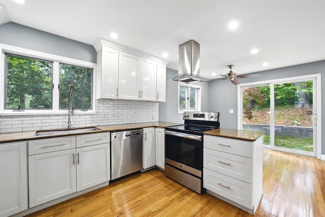 1 Renee Gate St, Cortlandt Manor, NY 10567 - kitchen featuring stainless steel appliances, island range hood, a sink, a peninsula, and a ceiling fan