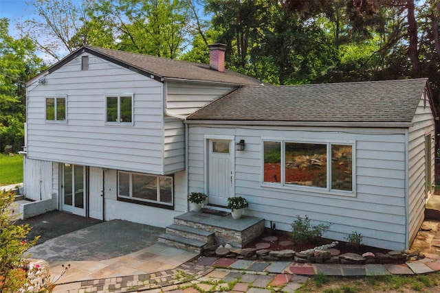 1 Renee Gate St, Cortlandt Manor, NY 10567 - back of house with roof with shingles, a chimney, and a patio