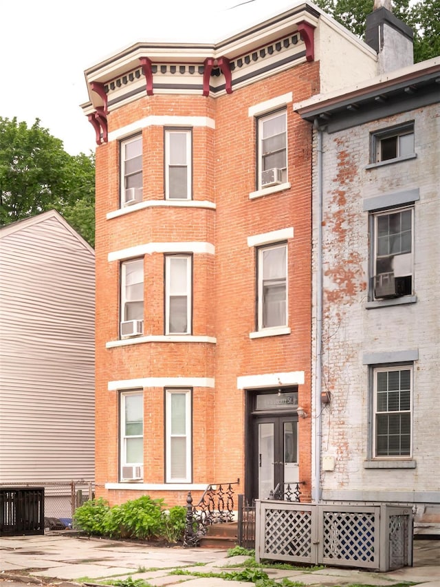 175 Liberty St, Newburgh, NY 12550 - view of front of property featuring brick siding, a chimney, and cooling unit