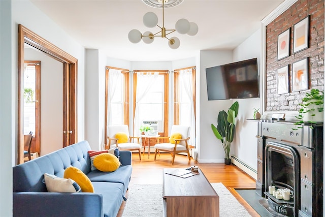 175 Liberty St, Newburgh, NY 12550 - living area featuring a baseboard radiator, light wood-type flooring, and a chandelier