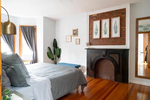 175 Liberty St, Newburgh, NY 12550 - bedroom featuring wood finished floors and a fireplace