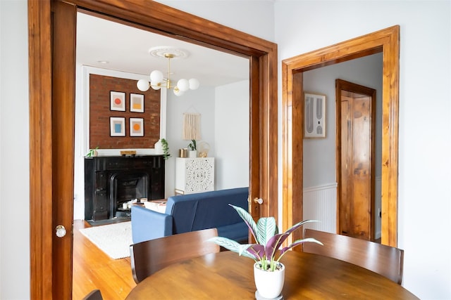 175 Liberty St, Newburgh, NY 12550 - dining room with a fireplace, a chandelier, and wainscoting