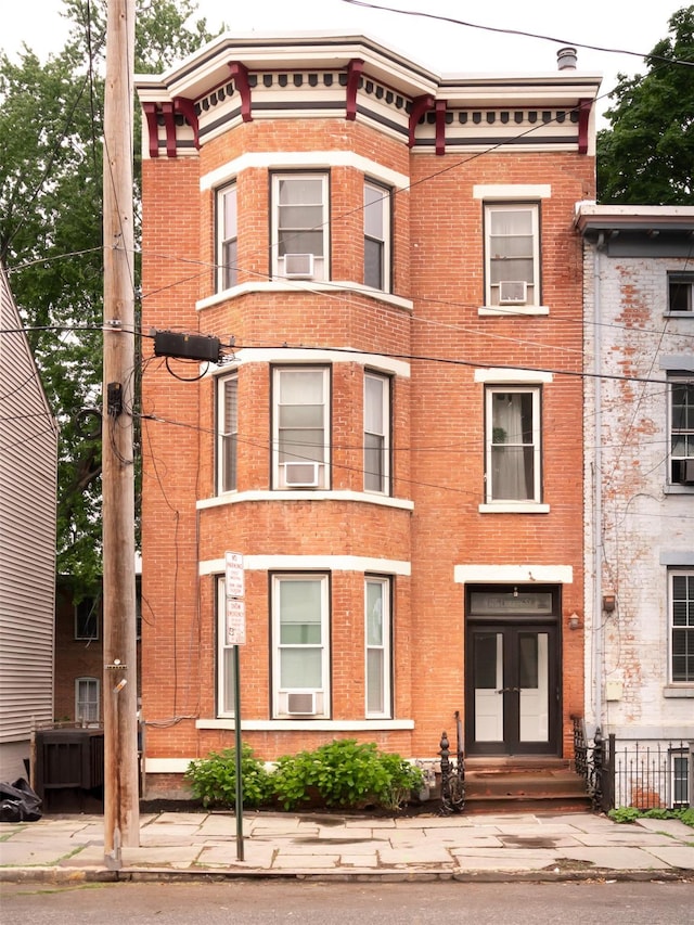 175 Liberty St, Newburgh, NY 12550 - view of front of home with brick siding, cooling unit, and french doors