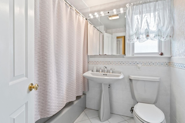 74 Buckingham Rd, West Hempstead, NY 11552 - bathroom with tile patterned flooring, tile walls, toilet, and shower / bath combo with shower curtain